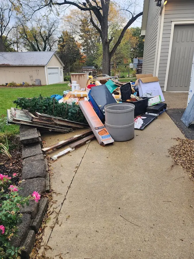 Dumpster being loaded with debris for 30 Yard Dumpster Rental in Mounds View